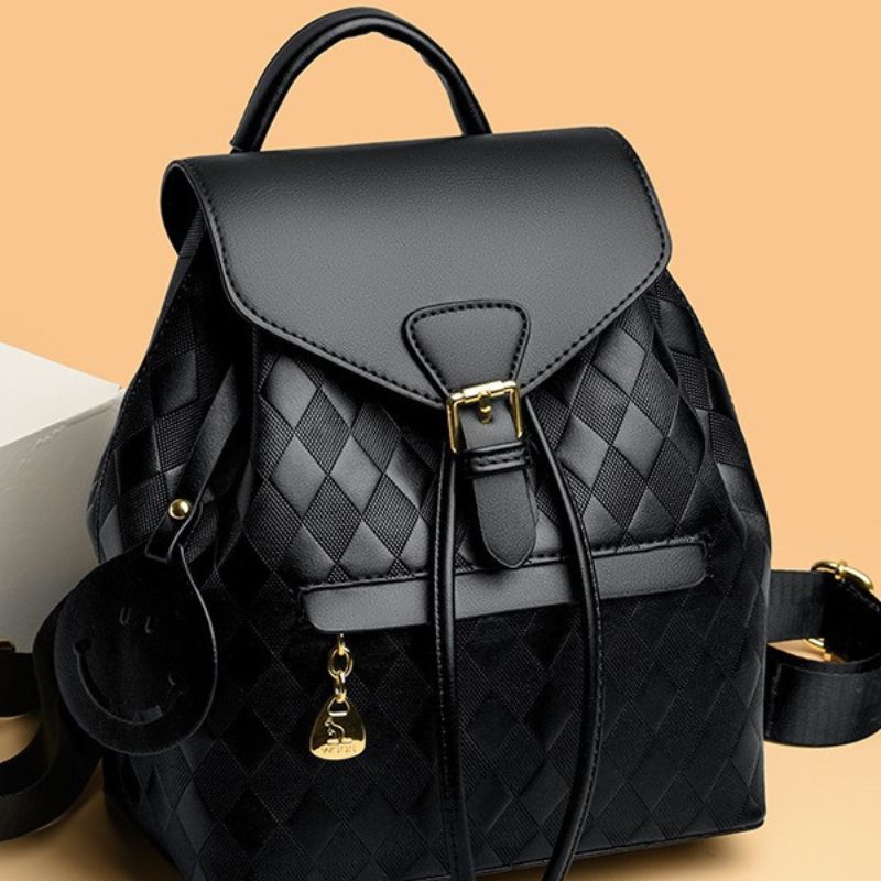 Stylish black quilted leather backpack featuring a flap closure with gold buckle, adjustable straps and a small gold charm accessory