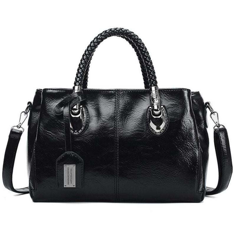 Black leather handbag with braided handle on a white background