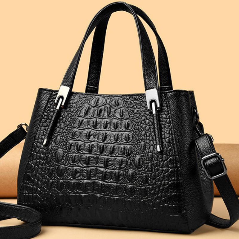 black crocodile handle hand on colorful background