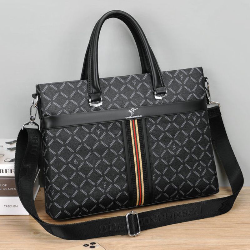 Black patterned handbag with a visible brand logo on a wooden surface.