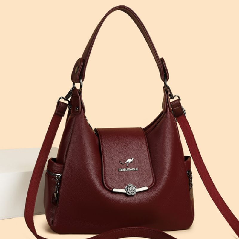 Brown handbag with a visible brand logo on a beige background