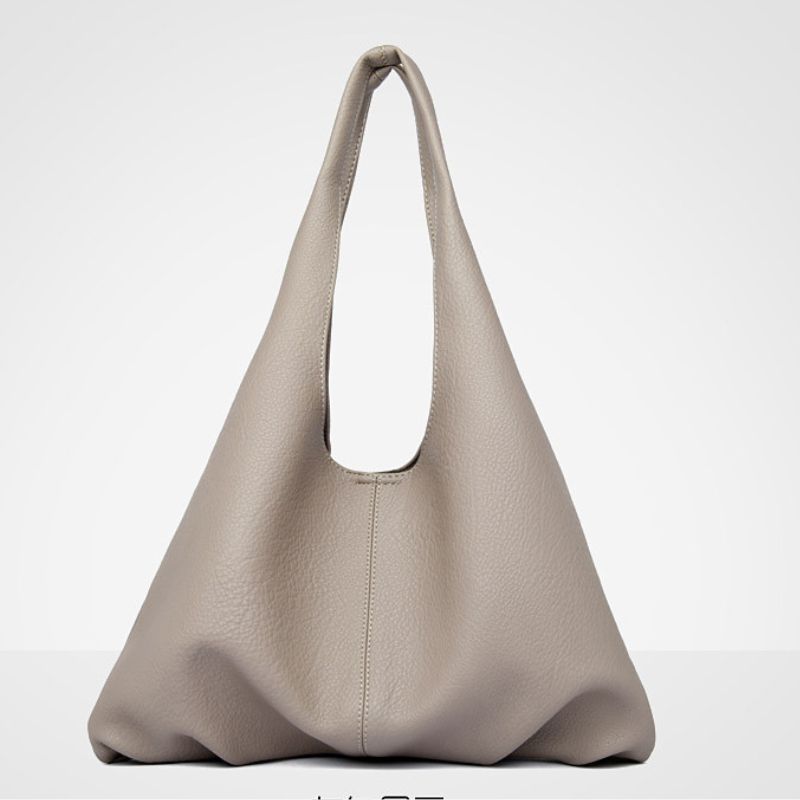 Beige handbag on a light gray background