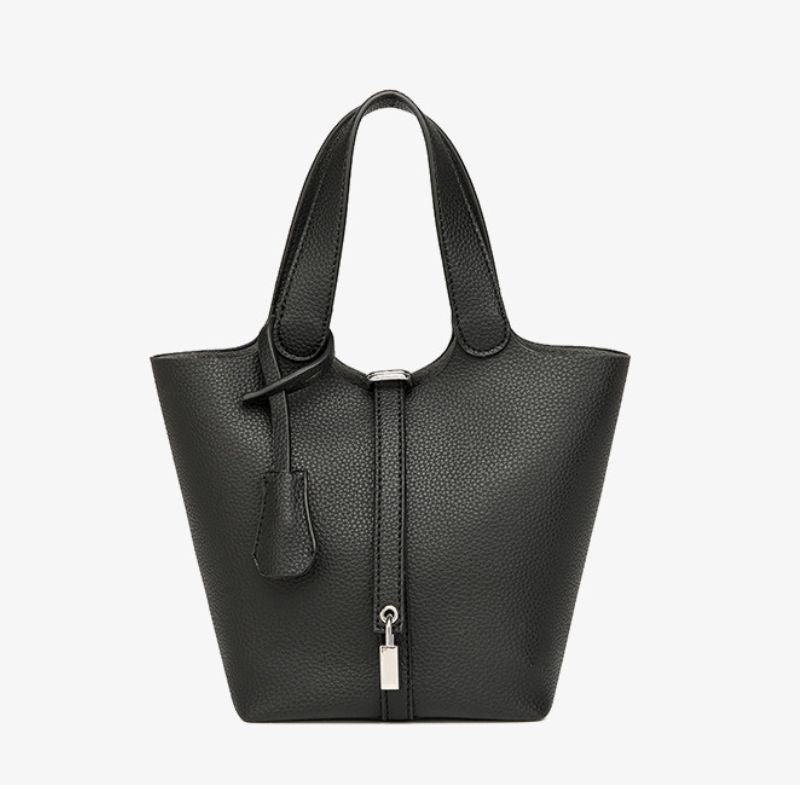 Black leather handbag with a zipper on a white background
