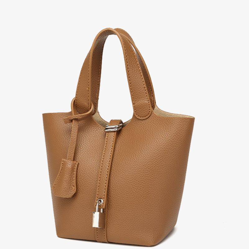Brown leather handbag with a strap on a white background