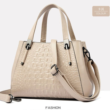 Beige handbag with crocodile texture on a light gray background