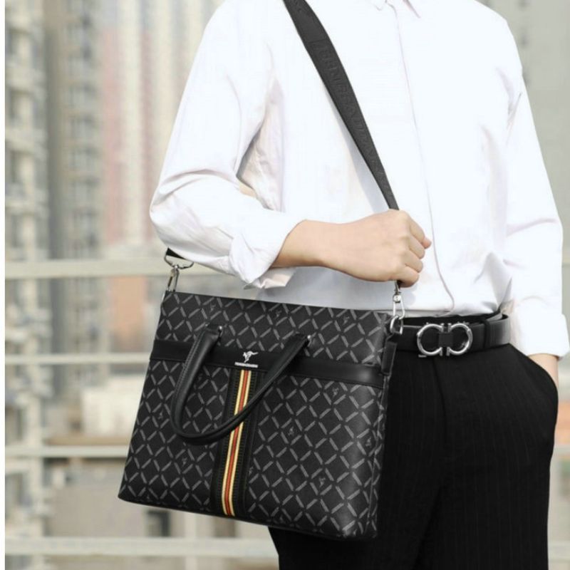 Person wearing a black patterned handbag with a blurred background