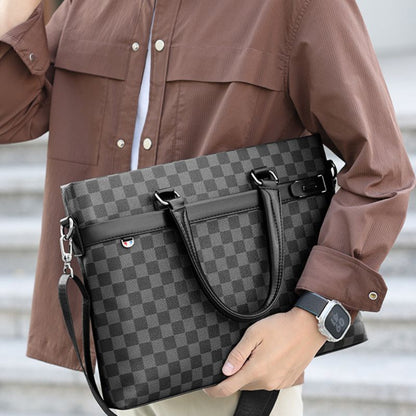 Person holding a gray checkered handbag with a blurred background