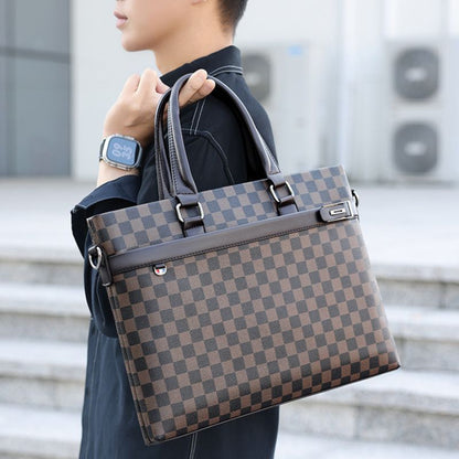 Person holding a brown and black checkered handbag with a blurred background