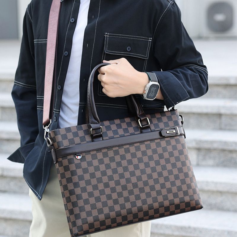Person holding a brown checkered bag with a blurred background