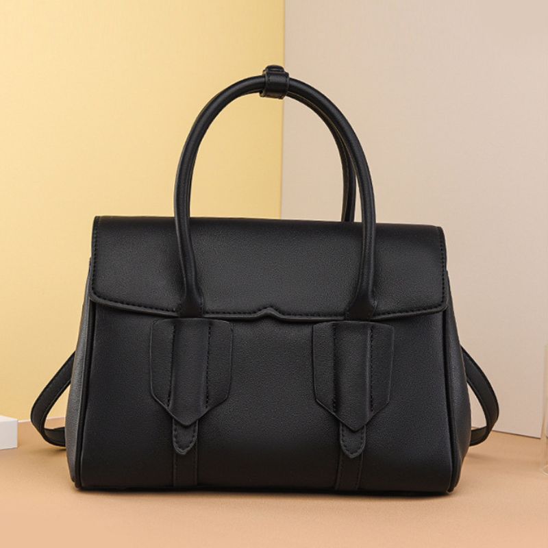Black handbag on a beige background