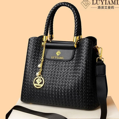 Black handbag with gold accents on a beige background, featuring the LUYIAMI brand.