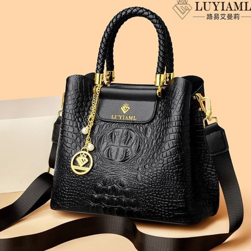 Black textured handbag with gold accents on a beige background, featuring the LUYIAML brand.