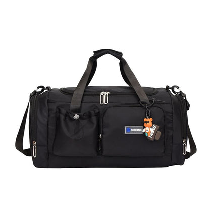 Black duffel bag with multiple pockets and straps on a white background