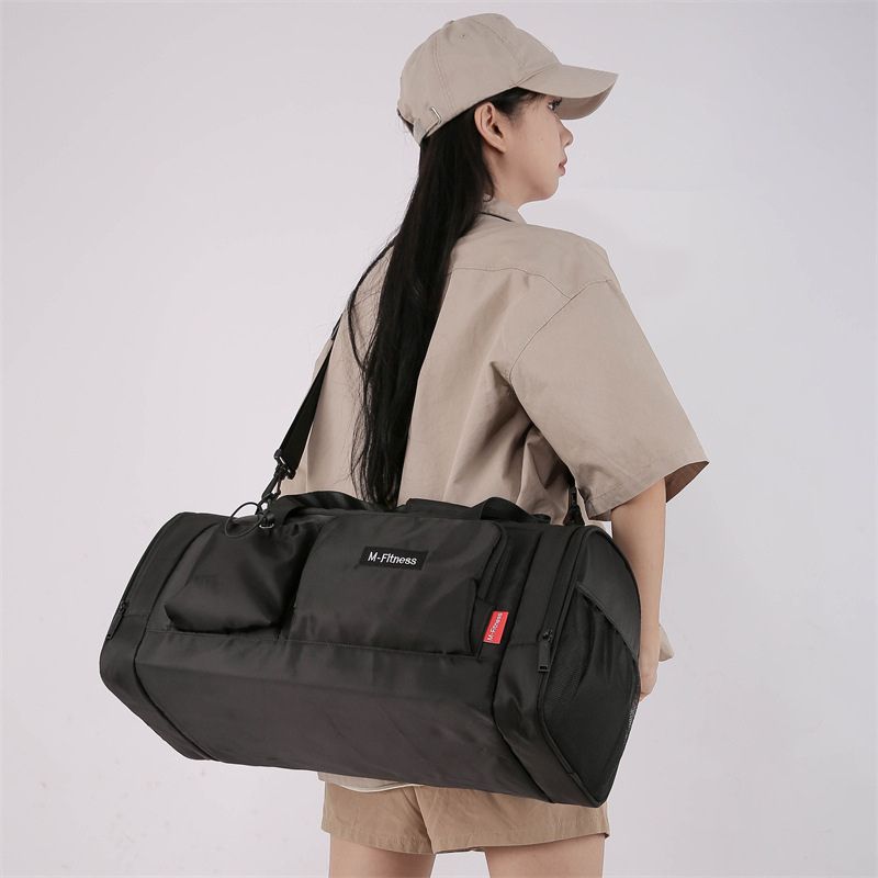 Person wearing a beige cap and outfit with a black duffel bag on a white background