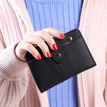 Person holding a black wallet with red nail polish
