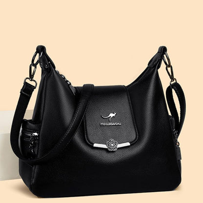 Black handbag with a visible brand logo on a beige background