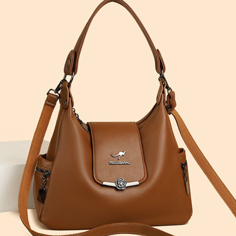 Brown handbag with a visible brand logo on a beige background