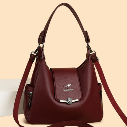 Brown handbag with a visible brand logo on a beige background