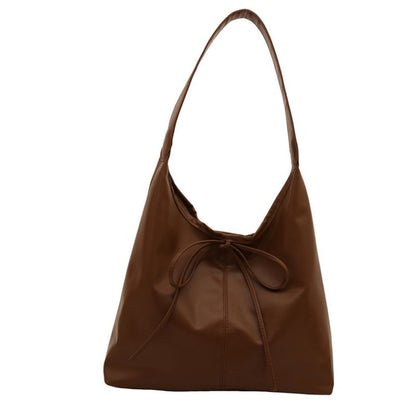 Brown ladies hand tote bag on white background.