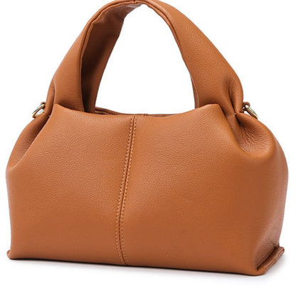 Brown leather handbag on a white background