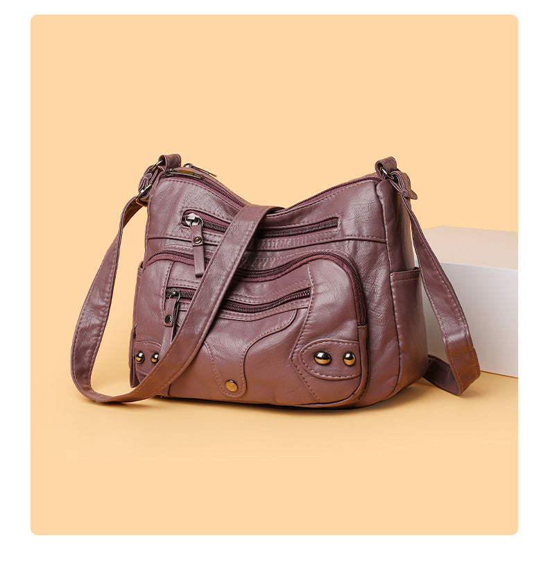 Brown leather handbag on a beige background