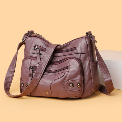 Brown leather handbag on a beige background