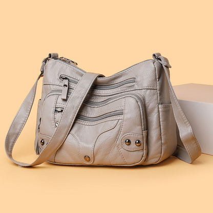 Gray leather handbag on a beige background