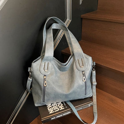 Blue handbag on a book with a staircase in the background
