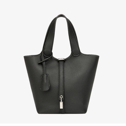 Black leather handbag with a zipper on a white background